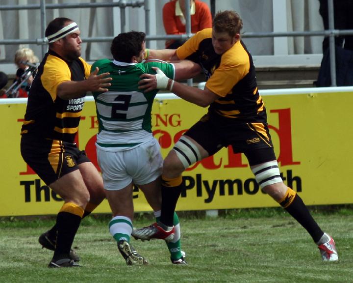 Sam Heard and Mark Bright stop Devon's Gareth Evans.jpg - Sam Heard and Mark Bright stop Devon's Gareth Evans. Photo by John Beach.